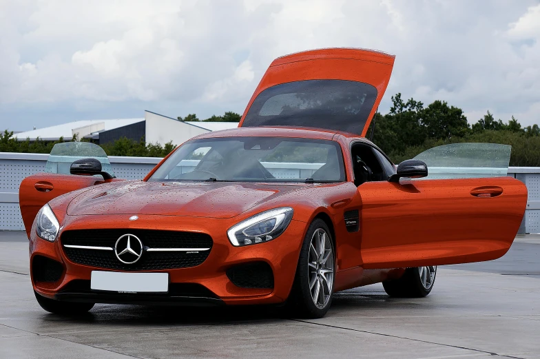 an orange sports car is parked in the parking lot