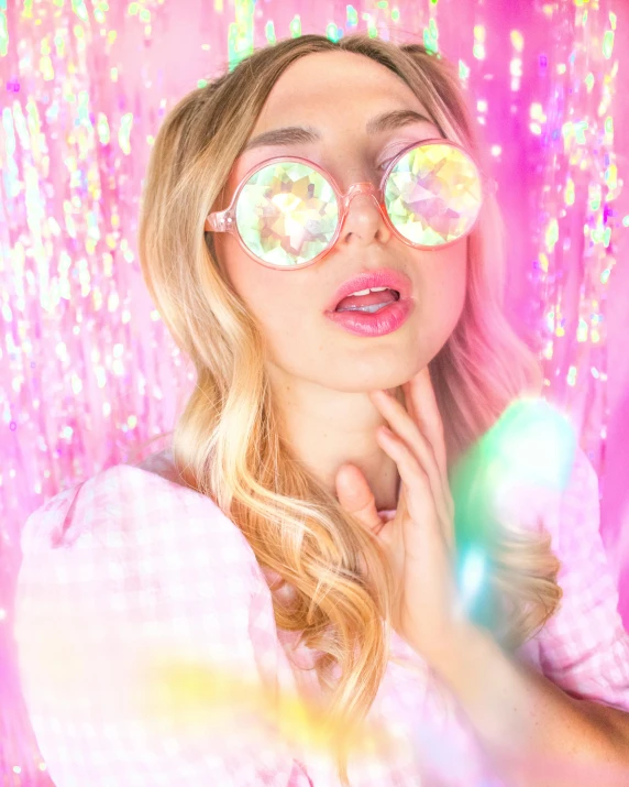 a beautiful woman in pink shirt and mirrored glasses