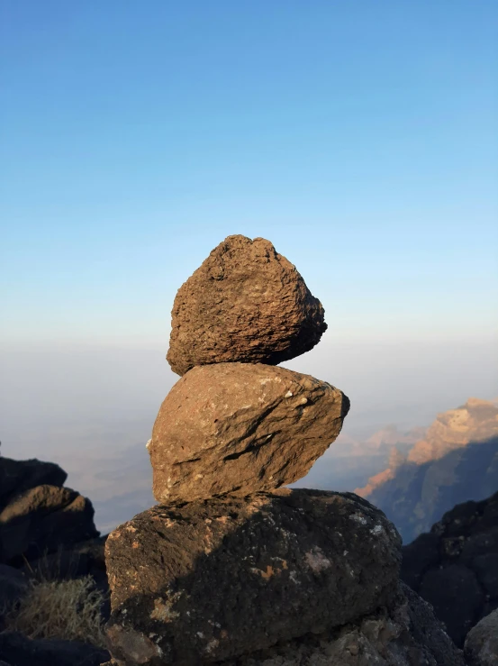 a stack of rocks sitting on top of a mountain