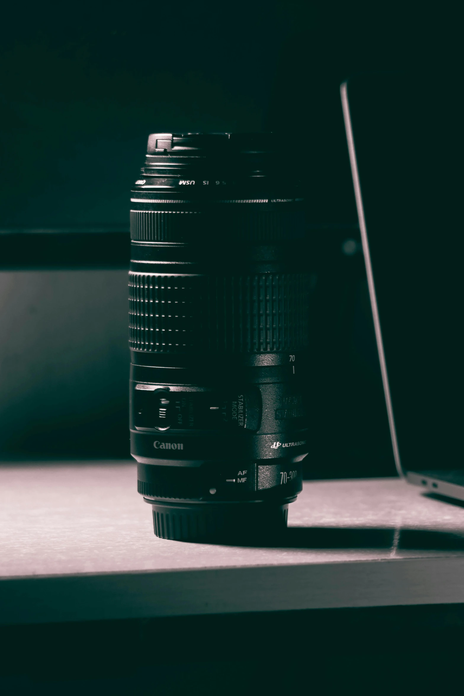 camera lens in front of laptop, on a table