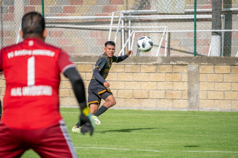 two guys are on the soccer field playing