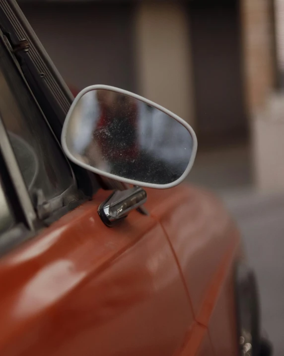 a side view mirror on a red car