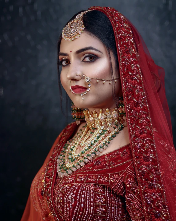 a beautiful woman in a red outfit with a gold and silver necklace