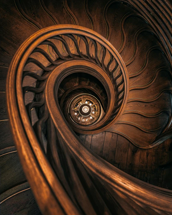 a spiral staircase made out of wood with glass in the center