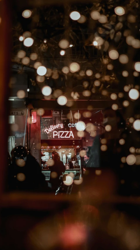 a restaurant with light raindrops on the windows and in the building