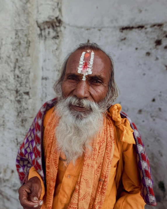 the man has painted on his forehead with a name