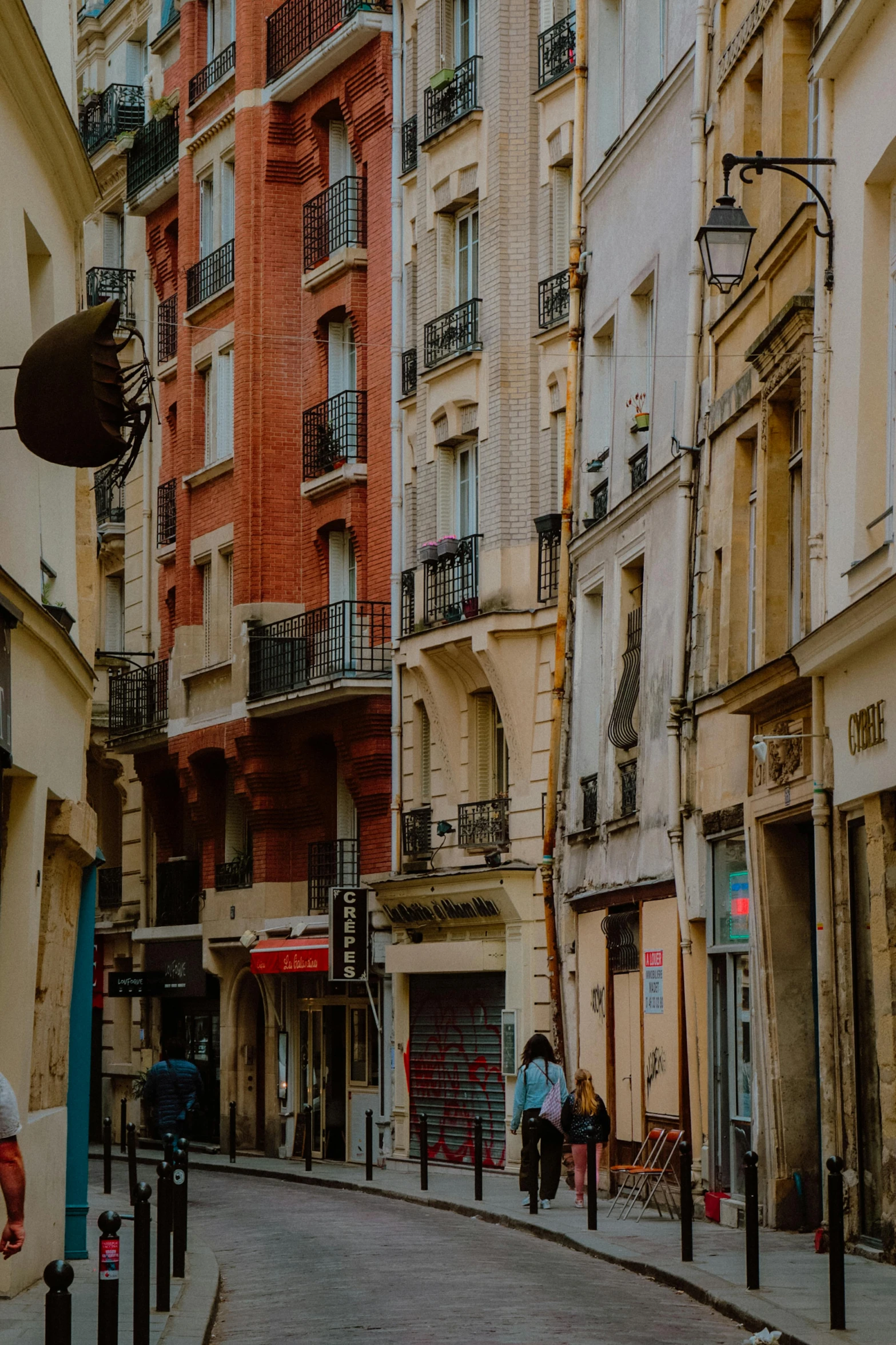 an empty city street is shown with cars and people