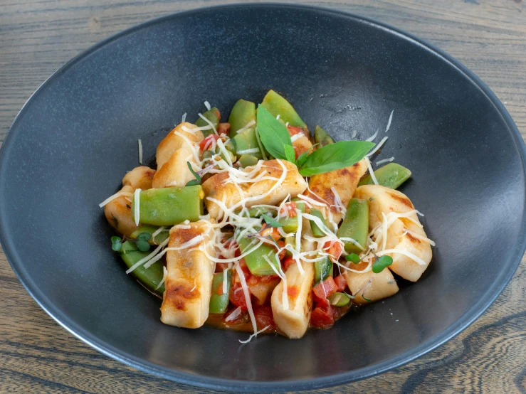 a pasta dish is made in a wok on the table