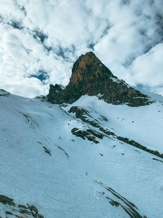 a man is skiing down the snow covered mountains