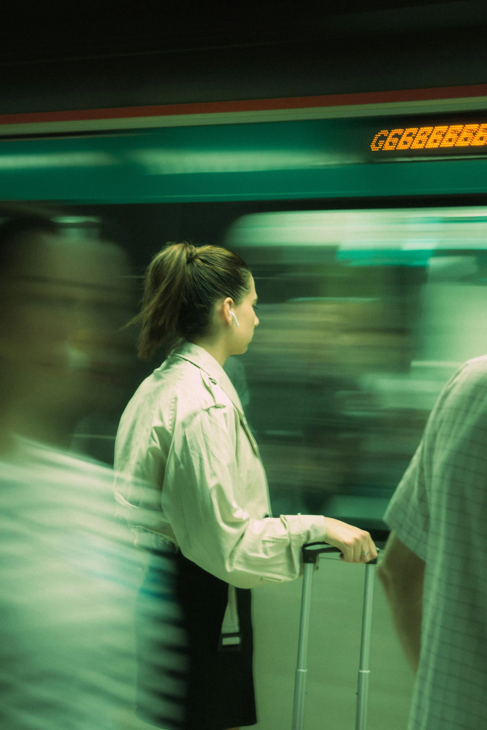 the woman is waiting for the train to arrive