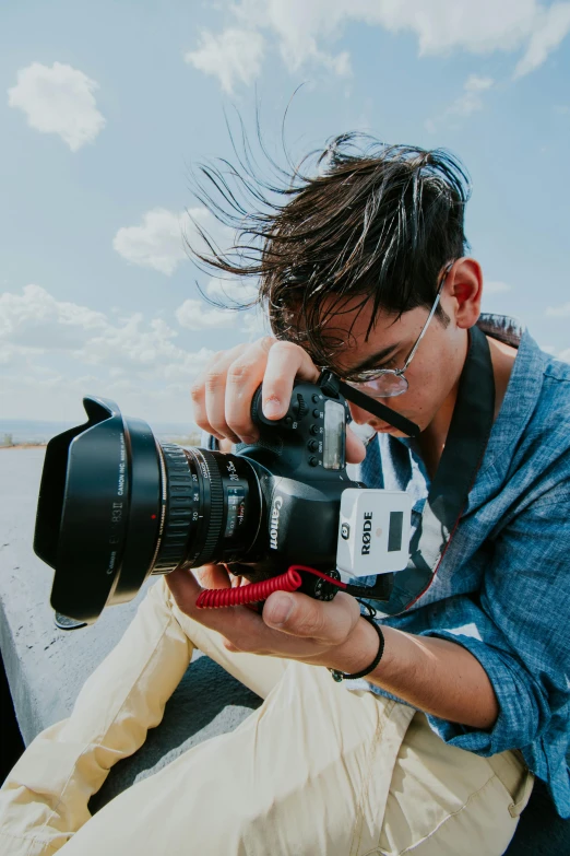 a man taking a po with a dslr and other equipment