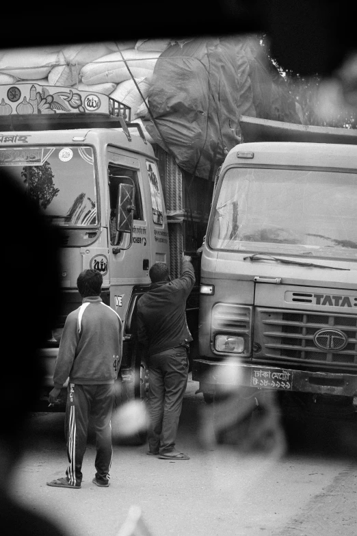 a group of people standing around two food trucks