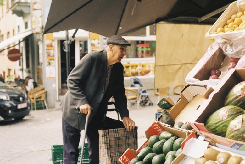 a man with a large piece of luggage stands outside