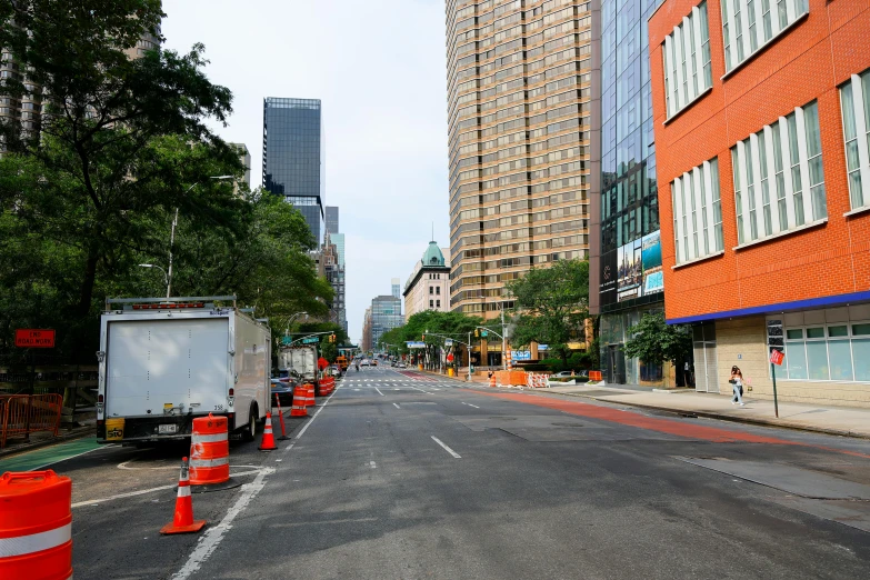 traffic cones are on the side of an empty street