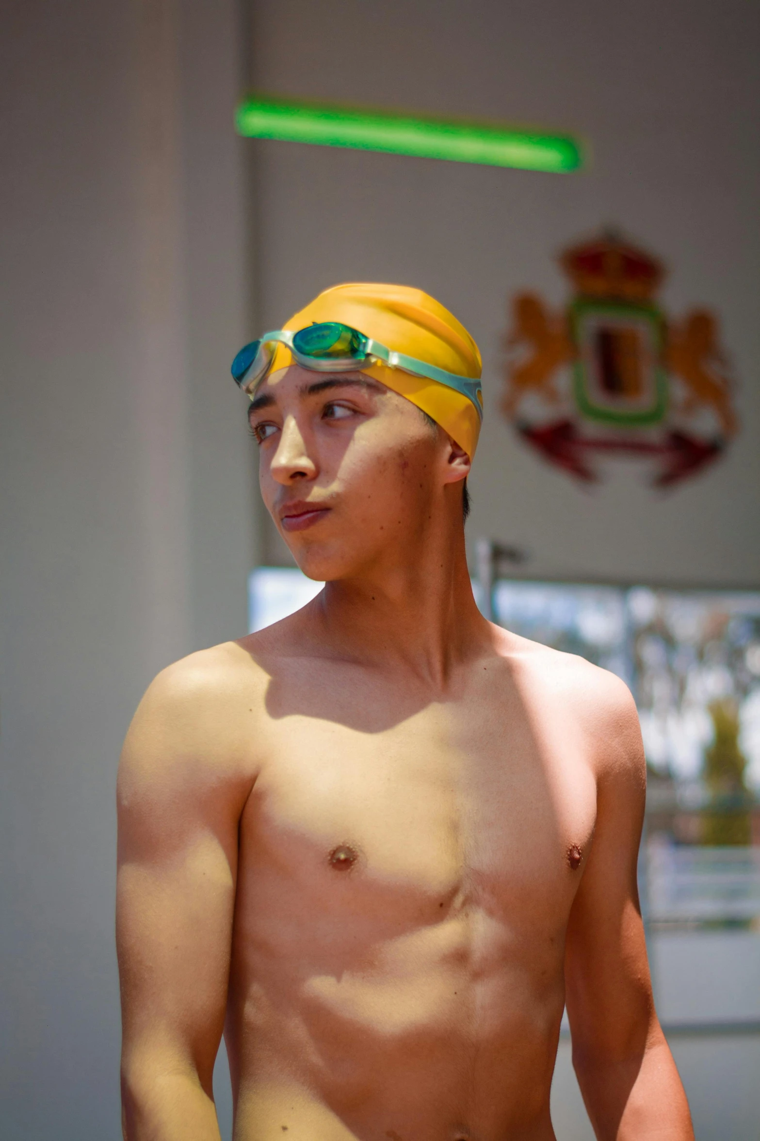 a man with  wearing a yellow head band and swimming goggles