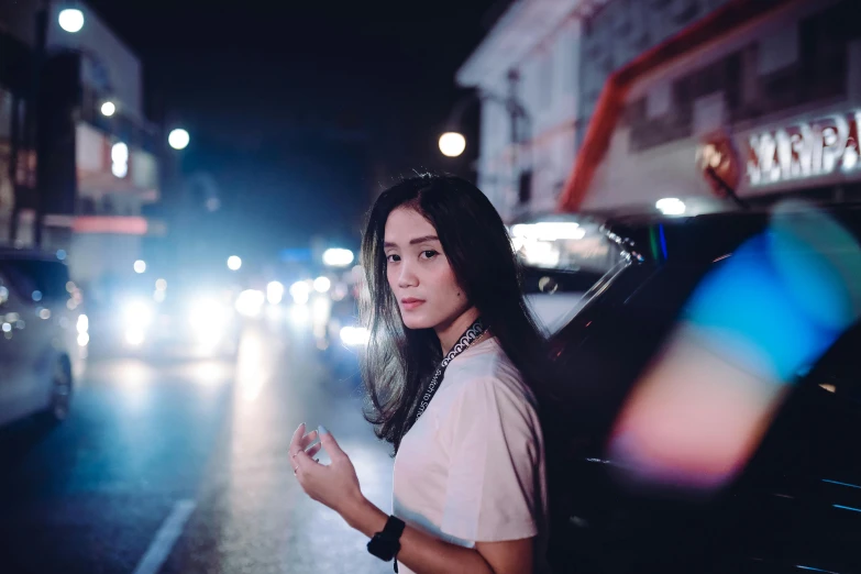 a woman is standing outside in the dark