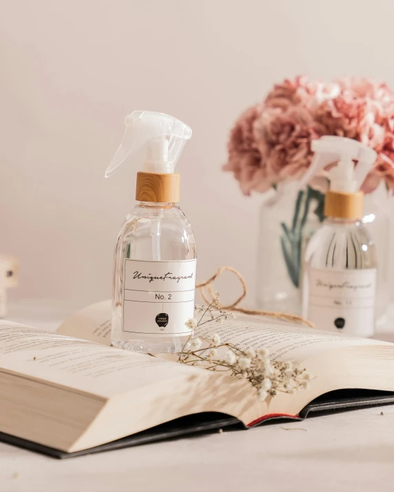 a bottle of liquid sitting on top of a book