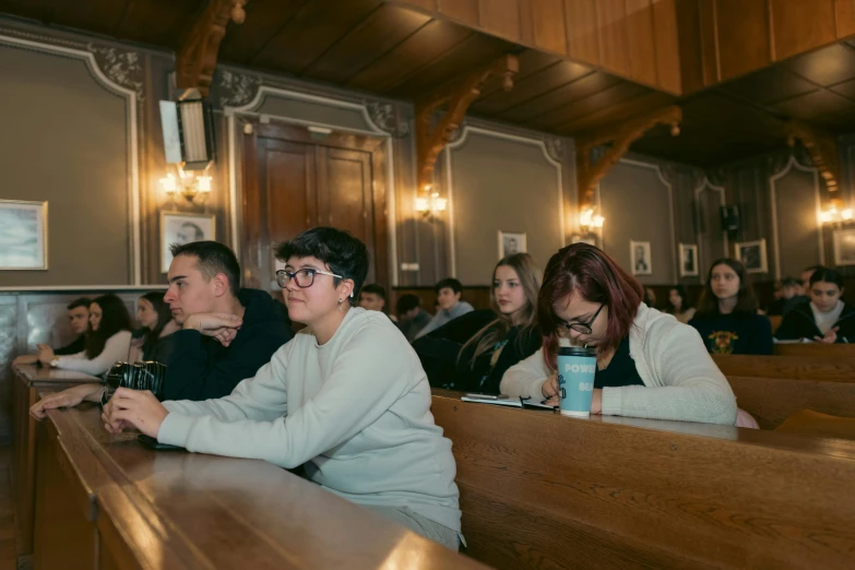 several people are sitting in the pews at a catholic church