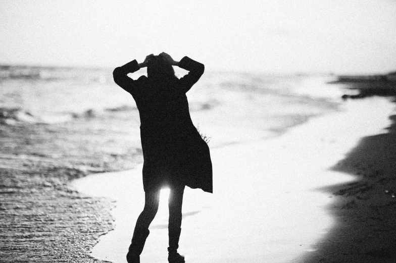 silhouette of a woman standing on the beach