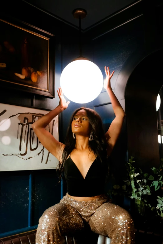 a woman posing for a po with a disco ball in her hand