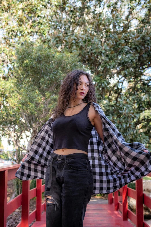 a young woman poses for a pograph wearing black and white checkerered