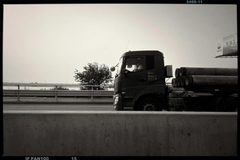 black and white pograph of truck and highway