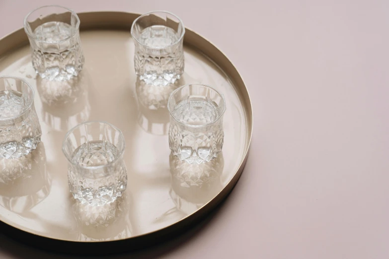 a glass of water is placed on a plate