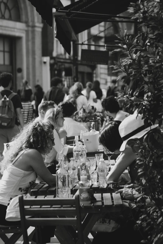 several people sitting around a table at an outdoor table