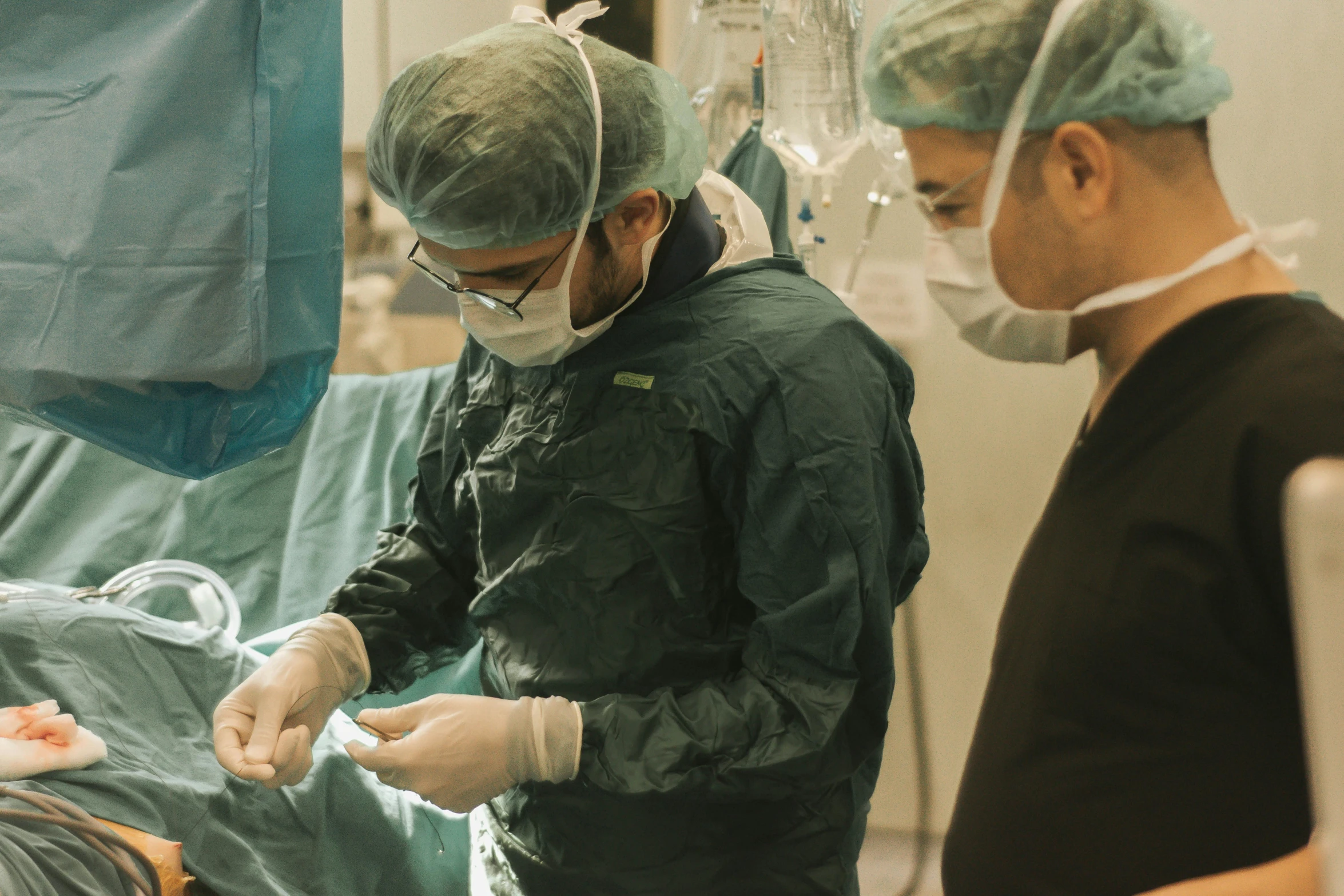 a dentist wearing masks tending to a patient