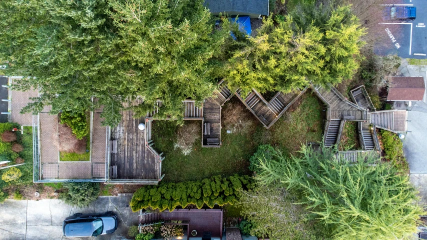 an aerial view of a small backyard with steps and bushes