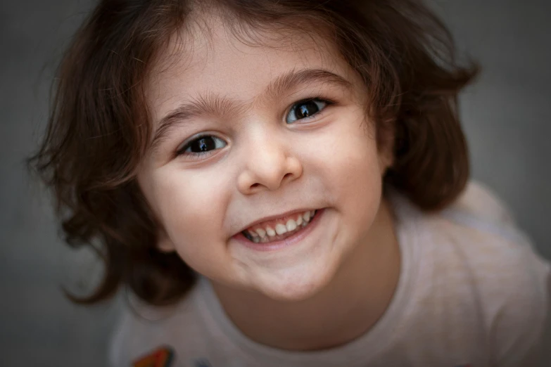 a close up of a young child smiling