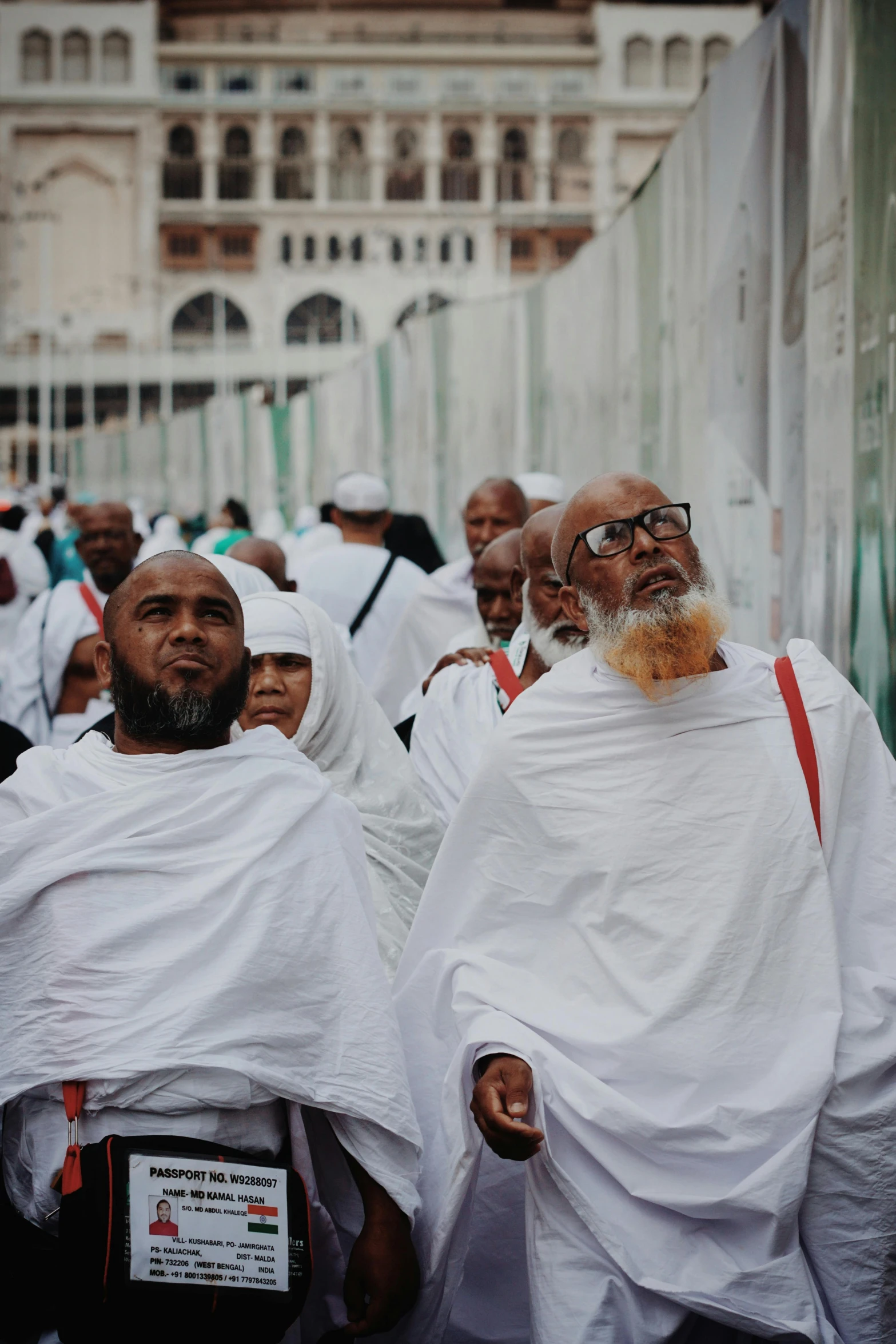 group of men with white robe and beards standing in a line