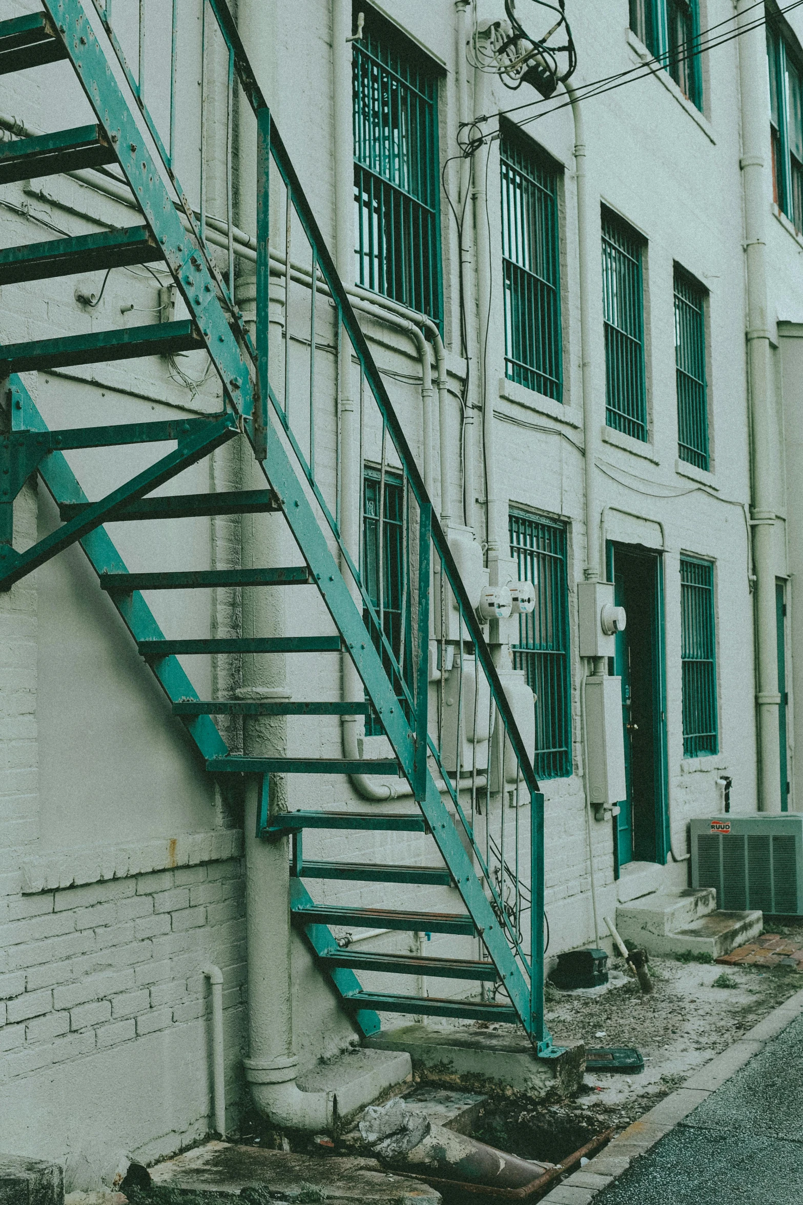 a blue handrail next to a white building