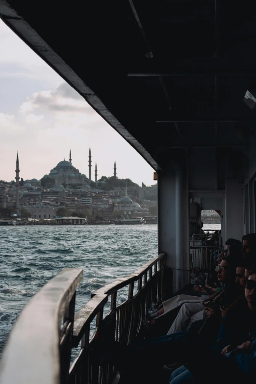 people standing outside a building near water