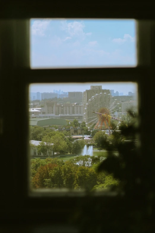 an overview through a window of some buildings and amut park