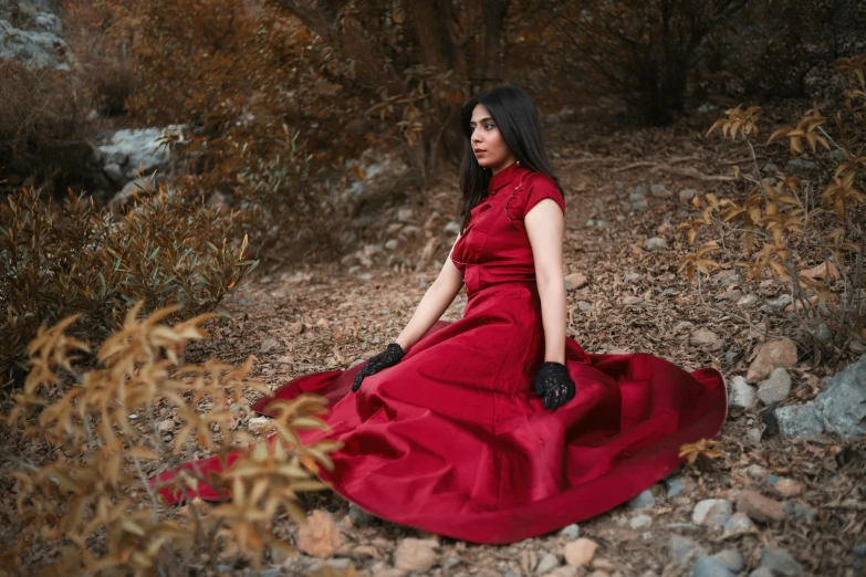 a woman is in a long red dress