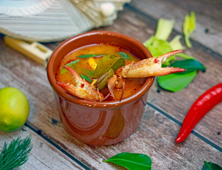 a bowl of crab soup and some chili