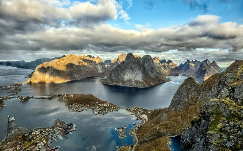 the view from a flight of the mountains surrounding an island and ocean