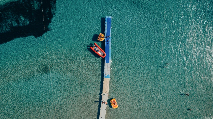 four boats tied to a dock in a large body of water