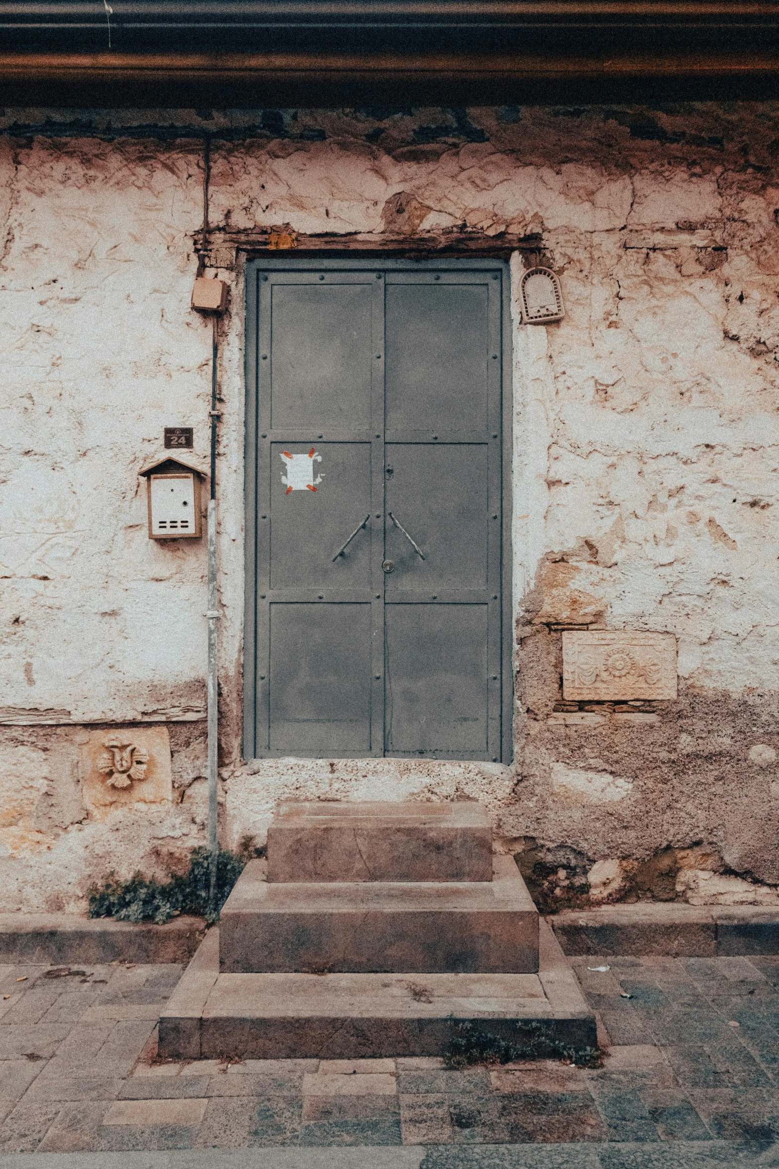 a wooden bench in front of a door on a building