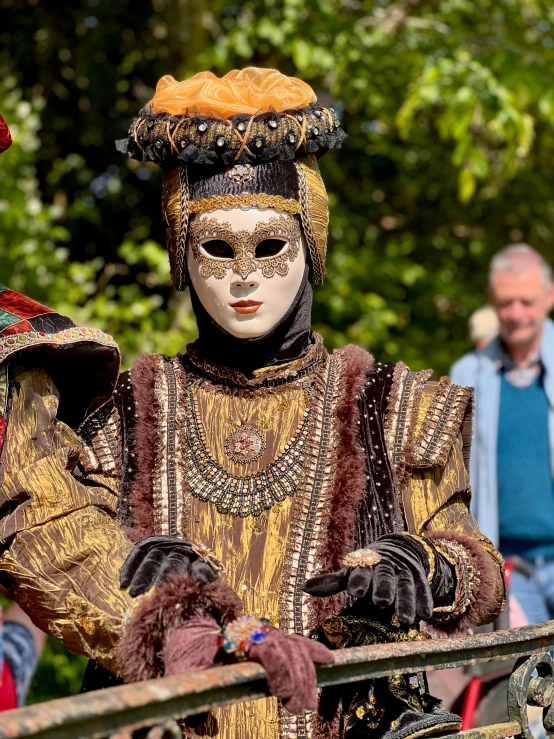 a statue of a person wearing a mask and a costume