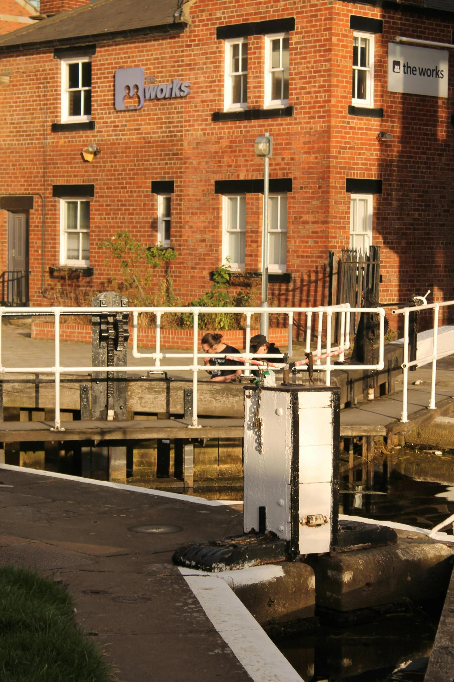 the entrance to a business with a white bridge crossing