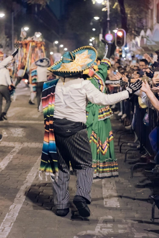 the men and women are dressed in mexican attire