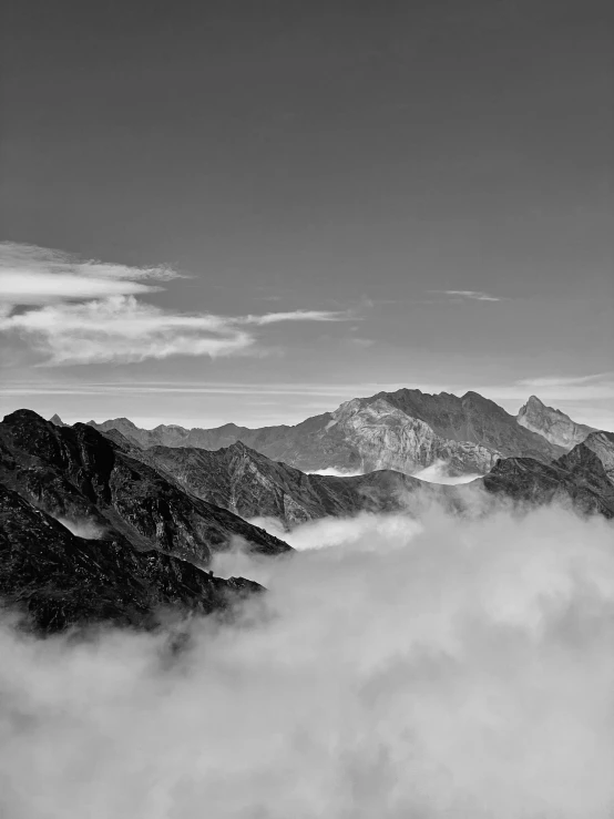 a black and white po of a fog filled mountains