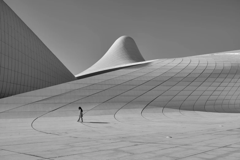 a woman standing in front of an interesting building