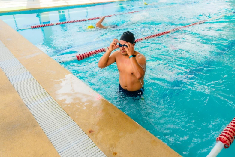 a man in a swimming pool talking on his phone