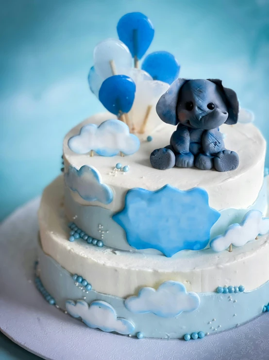 a baby elephant is sitting on top of a cake