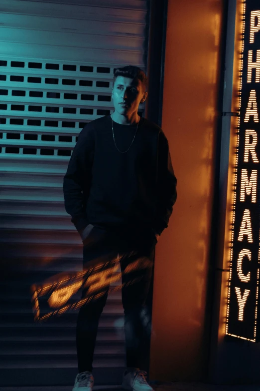 the man is standing next to a theatre sign