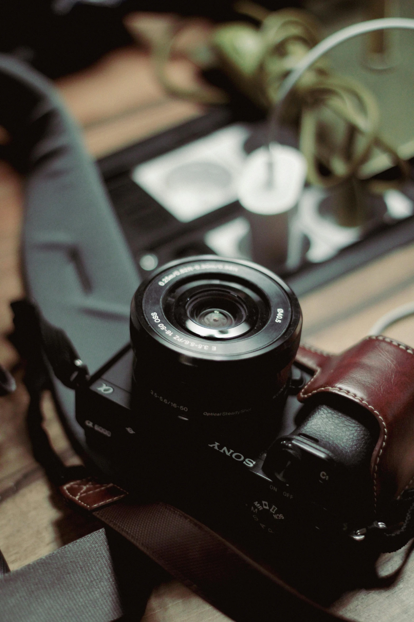 a camera on a wooden surface with other equipment