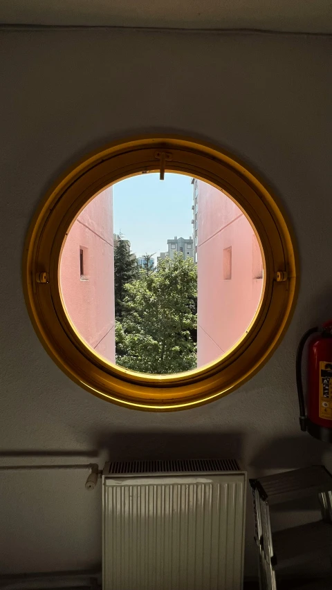 a small round window that is on a wall